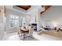 Open concept dining and living area with fireplace and vaulted wood ceilings at 867 Hill And Dale Rd # B, Golden, CO 80401