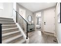 Bright entryway with stairs, modern decor, and a glimpse into the primary bedroom at 4739 Gray Wolf Ln, Castle Rock, CO 80104