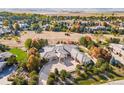 Sprawling residence nestled within a community featuring lush landscaping, mature trees, and serene views at 8833 Portico Ln, Longmont, CO 80503