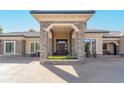 Inviting front entrance boasting a stone-clad portico and a solid wood door at 8833 Portico Ln, Longmont, CO 80503