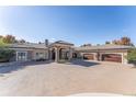 Grand home featuring porte-cochere, large driveway, and multiple car garage at 8833 Portico Ln, Longmont, CO 80503