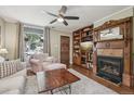 Cozy living room features a fireplace, custom built-ins and natural light at 4165 Winona Ct, Denver, CO 80212