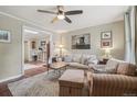 Comfortable living room showcasing hardwood floors, a soft rug and stylish furnishings at 4165 Winona Ct, Denver, CO 80212