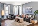 Living room with hardwood floors, a neutral color palette, and comfy furniture at 14721 E Poundstone Dr, Aurora, CO 80015