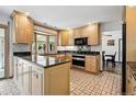 Bright kitchen featuring custom cabinets, granite countertops, and lots of natural light at 5197 S Perry St, Littleton, CO 80123