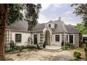 Charming home with unique brick accents, a stone driveway and lush landscaping at 620 Clermont St, Denver, CO 80220