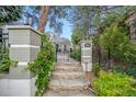 Charming home exterior featuring brick pillars, stone steps, and gated entrance at 620 Clermont St, Denver, CO 80220