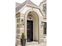 Detailed view of the home's front door, arched entryway, and classic exterior lighting at 620 Clermont St, Denver, CO 80220