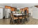 Beautiful kitchen featuring stainless steel appliances, wood cabinets, and a large center island with seating at 6502 W 96Th Ave, Westminster, CO 80021