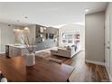 Open-concept living room featuring hardwood floors, modern decor, and a spacious layout perfect for entertaining at 210 S Cherrywood Dr # 303, Lafayette, CO 80026