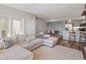 Cozy living room with neutral decor, an open floor plan, and access to the kitchen and outdoor space at 210 S Cherrywood Dr # 303, Lafayette, CO 80026