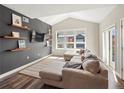 Bright living room with vaulted ceilings, built-in shelving, and a large window offering ample natural light at 210 S Cherrywood Dr # 303, Lafayette, CO 80026