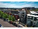 An aerial view of a modern townhouse complex, showcasing its architecture and urban setting at 2650 W Front View Crescent Dr # 101, Denver, CO 80211