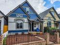 Charming blue and white Victorian-style home with a lovely front porch and well-kept landscaping at 160 W Bayaud Ave, Denver, CO 80223