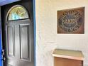 Close up of front door with ornate stained glass window and Historic Baker District sign at 160 W Bayaud Ave, Denver, CO 80223