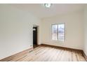 Bright living room with hardwood floors, a large window, and neutral walls offers a modern and inviting space at 160 W Bayaud Ave, Denver, CO 80223