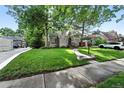 A charming home with a lush green lawn, mature trees, and well-maintained landscaping, enhancing curb appeal at 1731 Locust St, Denver, CO 80220
