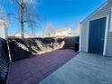 Cozy brick patio in fenced backyard, perfect for outdoor entertaining or relaxing at 4111 E 94Th Ave # E, Thornton, CO 80229