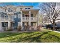 Charming two-story townhome featuring a welcoming blue exterior and landscaped front yard at 9478 E 108Th Ave, Commerce City, CO 80640