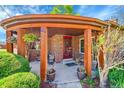 Inviting covered front porch with brick accents, decorative hanging plants, and updated lighting at 2901 Monaco Pkwy, Denver, CO 80207