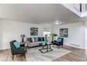 Inviting living room with cozy seating, modern art, and ample natural light, creating a comfortable space at 11183 E 114Th Ave, Commerce City, CO 80640