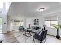 Spacious living room with large windows, comfortable seating, and stylish decor, perfect for relaxation and entertaining at 11183 E 114Th Ave, Commerce City, CO 80640