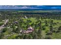 Panoramic aerial view of a home nestled within a lush green forest with scenic mountain views at 5519 Ponderosa Dr, Parker, CO 80134