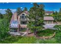 Two-story home featuring a solarium, back porch, and an attached two car garage at 5519 Ponderosa Dr, Parker, CO 80134
