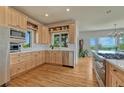 Well-lit kitchen featuring a large window, stainless steel appliances, and wood cabinets at 5519 Ponderosa Dr, Parker, CO 80134