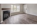 Cozy living room featuring a fireplace and a large bay window, creating a warm ambiance at 9624 W Chatfield Ave # D, Littleton, CO 80128