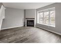 Comfortable living space with a fireplace and natural light streaming through the large window at 9624 W Chatfield Ave # D, Littleton, CO 80128