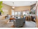 Cozy living room with vaulted ceilings, stylish furniture, wood burning fireplace, and access to the backyard at 8240 Clayton Ct, Denver, CO 80229