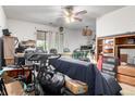 View of cluttered living room with ceiling fan and natural light at 2201 Sable Blvd # 1003, Aurora, CO 80011