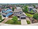 Two-story home with an attached garage, manicured lawn, and charming landscaping at 2150 Wagon Way, Louisville, CO 80027