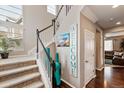 A staircase with carpeted steps leads to an upper level, with decoratively adorned walls and dark wood floors at 2636 Scoter Ln, Castle Rock, CO 80104