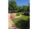 Secluded backyard featuring a lawn, decorative landscaping, and inviting outdoor area at 222 S Olive St, Denver, CO 80230