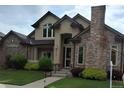Traditional home with brick accents, manicured landscaping, and inviting front entry at 222 S Olive St, Denver, CO 80230