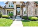Close-up of the home's entry with lovely landscaping and beautiful door at 222 S Olive St, Denver, CO 80230