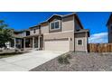 Charming two-story home with a two-car garage, well-maintained landscaping, and inviting curb appeal at 2325 Mountain Sky Dr, Fort Lupton, CO 80621