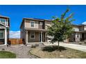 Charming two-story home with a well-manicured lawn, complemented by a cozy front porch at 2325 Mountain Sky Dr, Fort Lupton, CO 80621