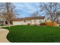 Lovely single-story home featuring a well-maintained lawn and an attached two-car garage at 16397 E Wyoming Dr, Aurora, CO 80017
