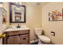 Stylish powder room featuring a modern vanity, sleek fixtures, and contemporary artwork at 7250 Eastmoor Dr # 119, Denver, CO 80237