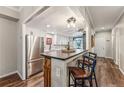 Modern kitchen features stainless steel appliances, white cabinets, and a breakfast bar with seating at 7250 Eastmoor Dr # 119, Denver, CO 80237