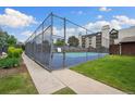 Outdoor community tennis court with a blue and green surface and secure fencing at 7250 Eastmoor Dr # 119, Denver, CO 80237