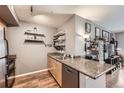 Kitchen with granite countertop, stainless steel appliances, and open shelving at 1623 Saint Paul St # 306, Denver, CO 80206