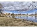 Scenic lake view with ducks, blue skies, and beautiful landscape with a building in the background at 1623 Saint Paul St # 306, Denver, CO 80206