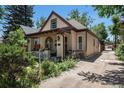 The home with a quaint front porch, nice exterior paint, and a driveway at 2234 W 35Th Ave, Denver, CO 80211