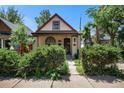 Charming home with beautiful landscaping and a quaint front porch at 2234 W 35Th Ave, Denver, CO 80211