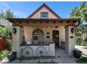 Charming front porch featuring decorative wagon wheels and exterior sconce lighting at 2234 W 35Th Ave, Denver, CO 80211
