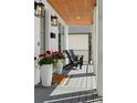 Cozy front porch with stylish chairs, potted flowers, and a warm welcome mat at 3256 S Corona, Englewood, CO 80113